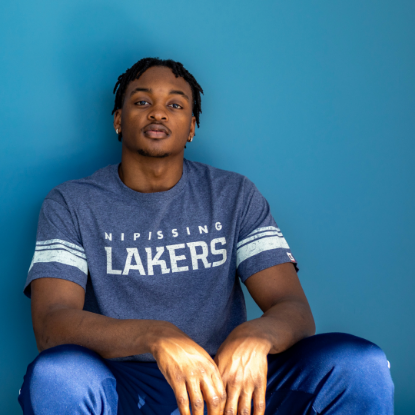 Student wearing blue Nipissing Lakers t-shirt with striped sleeves