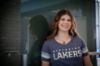 Student wearing a blue/grey v-neck tee with the Nipissing Lakers logo on the front