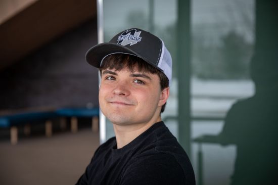 Student wearing a hat with the Nipissing Lakers logo on the front