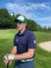 Student wearing a navy blue golf shirt with the Nipissing alumni logo on the left sleeve.