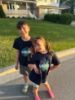 Two children wearing Navy tee-shirts with the NU Lakers logo on the front