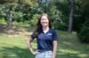 Woman wearing a Navy Lakers Golf Shirt with "Lakers" on the front right side.