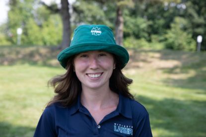 Close-up of student wearing a Green Tilley Hat with the "Alumni" logo on the front.