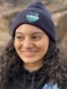 Student smiling with a Navy Lakers Beanie.