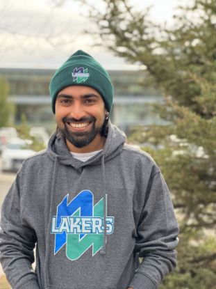 Male student wearing a forest green beanie.