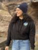 Student modelling a Lakers lightweight cropped hoodie in front of a rock.